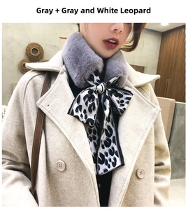 Detail of grey faux rabbit fur collar with black and white leopard print silk ribbon scarf