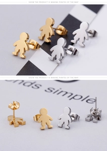 Detail of polished metal boy-shaped stud earrings in gold and silver finish
