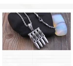 Detailed bullet-shaped skull pendant in silver steel with punk rock style relief