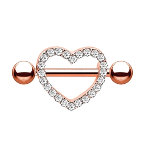 Macro detail of rose gold heart-shaped nipple ring set with sparkling zircon stones
