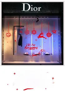 Macro detail of red Merry Christmas silhouettes with reindeer and snowflakes for window