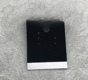 Detail of silver brushed metal and black velvet jewelry display card for earrings