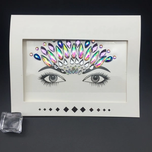 Face crystal stickers in iridescent AB and blue shades arranged on white card