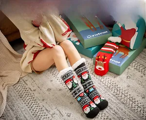 Close-up of thick fleece-lined Christmas socks with festive Reindeer and Santa patterns