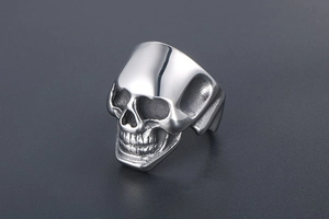 Detailed view of silver stainless steel skull ring with intricate rock style metal texture