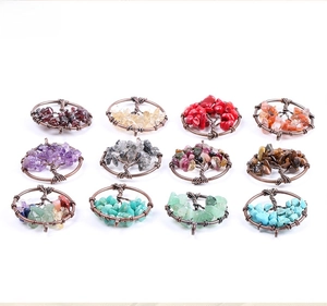 Detailed grid display of 12 assorted crystal tree of life pendants in various gemstones