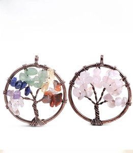 Detail of handmade Tree of Life pendants with bronze wire wrapping and colorful crystals