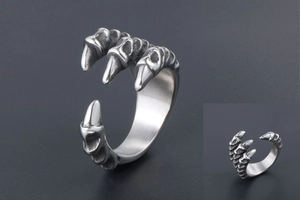 Macro detail of retro dragon claw ring with intricate scales and vintage silver finish