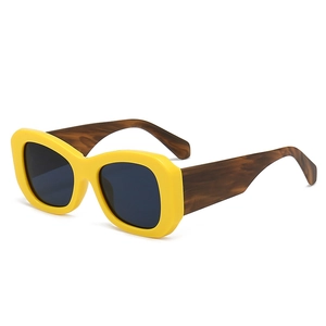 Modern oversized yellow frame sunglasses with amber pattern arms and dark lenses
