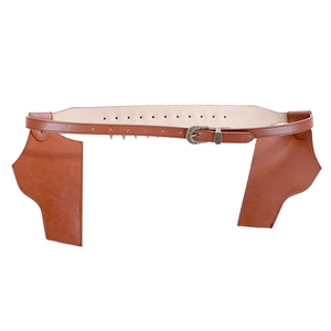 Detail of vintage brown leather cowboy gun holster belt with embossed metal buckles