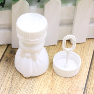 Detail of white wedding dress bubble bottle with wand for festive party favors
