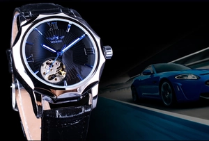 Detail view of the silver automatic watch featuring blue hands and skeleton dial movement