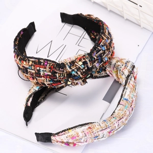 Detail shot of black and white tweed knotted headbands with woven texture and chic design