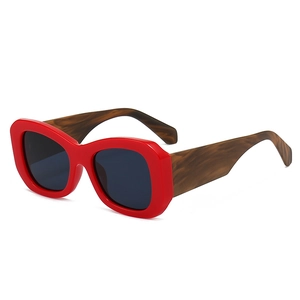 Modern red chunky frame sunglasses with brown wood grain temples and black lenses