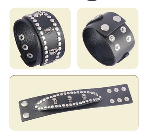 Detailed views of a wide black leather bracelet with skull motifs and silver studs