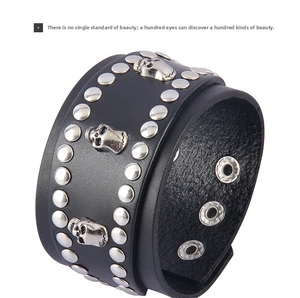 Close-up of black leather punk bracelet featuring silver metal studs and skull charms