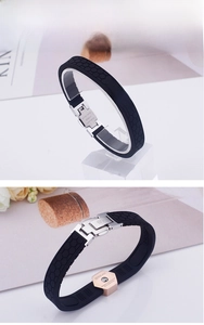 Detail of black silicone energy bracelet with honeycomb texture and rose gold steel clasp