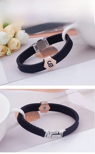 Detail of rose gold stainless steel clasp with engraving on black silicone sports wristband