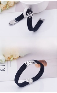 Detail view of black silicone sports bracelet with honeycomb texture and metal clasp