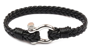 Close-up of black braided leather bracelet with silver horseshoe buckle on white background