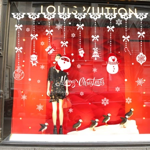 Christmas window stickers with white snowflakes, stockings, and Merry Christmas text