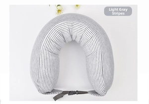 Detail of light grey striped U-shaped neck pillow with adjustable buckle strap and soft knit fabric