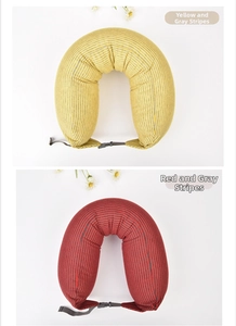 Close-up of U-shaped neck pillows in yellow-gray and red-gray stripes with snap closures