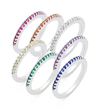 Macro detail of six rainbow eternity rings with colorful micro-inlaid zirconia stones