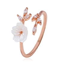 Detail of rose gold flower ring with pearl shell petals and marquise cubic zirconia leaves