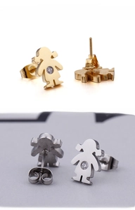 Detail of girl-shaped stud earrings in gold and silver finish with crystal zircon center
