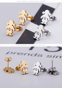 Detailed view of gold and silver girl-shaped stud earrings with clear cubic zirconia stones