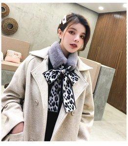 Close-up of grey faux fur scarf with stylish leopard print silk ribbon bow detail