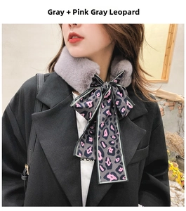 Detail of grey faux rabbit fur collar with pink leopard print silk ribbon bow tie