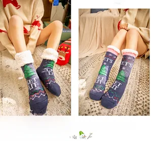 Detail of Christmas themed fleece lined thermal socks with reindeer and GET LIT patterns