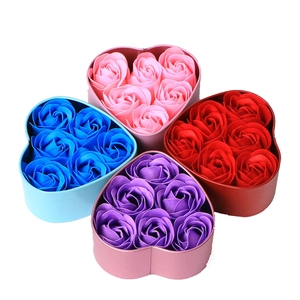 Macro shot of four heart-shaped gift boxes with six fragrant soap roses in various colors