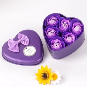 Close-up of purple heart-shaped metal gift box with six soap roses and a sweet love tag