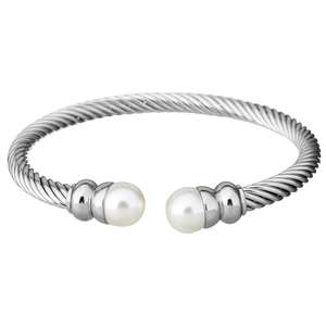Silver twisted cable cuff bracelet with white pearl end caps on white background