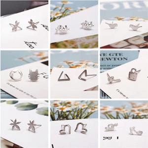 Collection of nine minimalist silver stud earrings in animal and geometric shapes