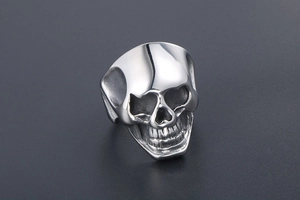 Macro shot of silver skull ring with creative heart eye details in punk steel style