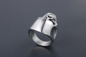 Detailed side view showing the metallic texture of the silver skull ring with high hat