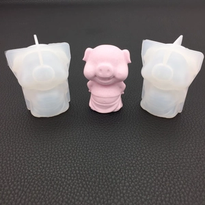 Detailed view of 3D pig silicone mold and a pink finished resin craft on black leather