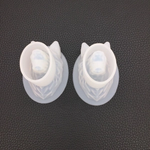 Macro view of two translucent geometric wolf head silicone molds for resin casting