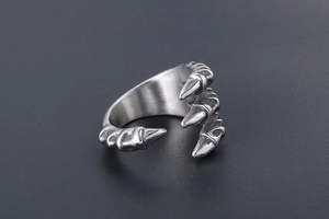 Macro detail of gothic dragon claw ring made of brushed silver stainless steel