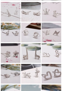 Macro display of various silver stud earrings featuring heart, swan, and animal shapes