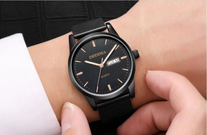 Close-up of men's black mesh watch featuring dual calendar and rose gold markers