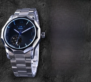 Side view of skeleton mechanical watch with silver stainless steel band and black dial