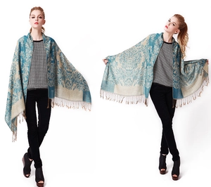 Detail of bohemian floral jacquard scarf with elegant fringe tassels and patterns