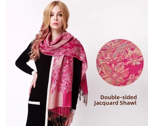 Close-up of double-sided rose pink jacquard shawl with tassel fringe and floral texture