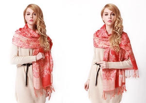 Detail of red floral bohemian shawl with fringe trim on female model