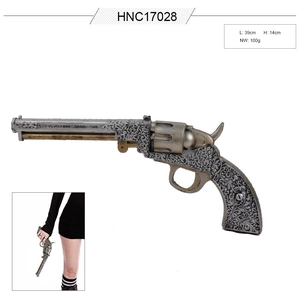 Detail of vintage cowboy revolver model with floral carvings and 39cm length specs